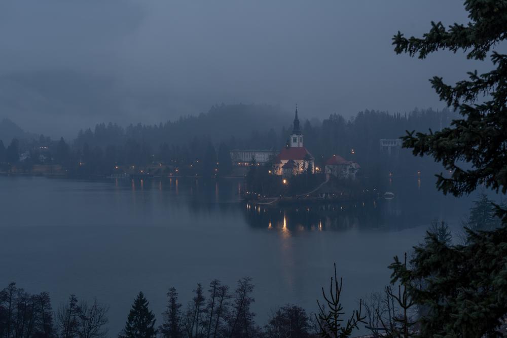 Lake bled lit up on a cold foggy winters evening, Slovenia
