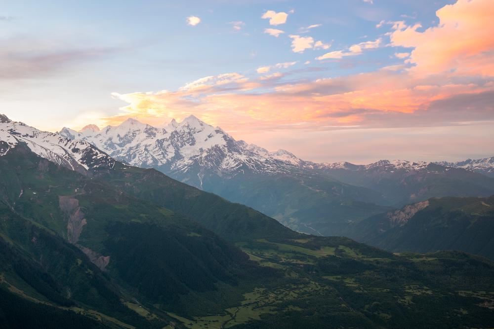 Pastel pink sunrise over a snowy mount Tetnuldi in Svaneti, Georgia